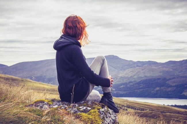 Woman relaxing on mountain top