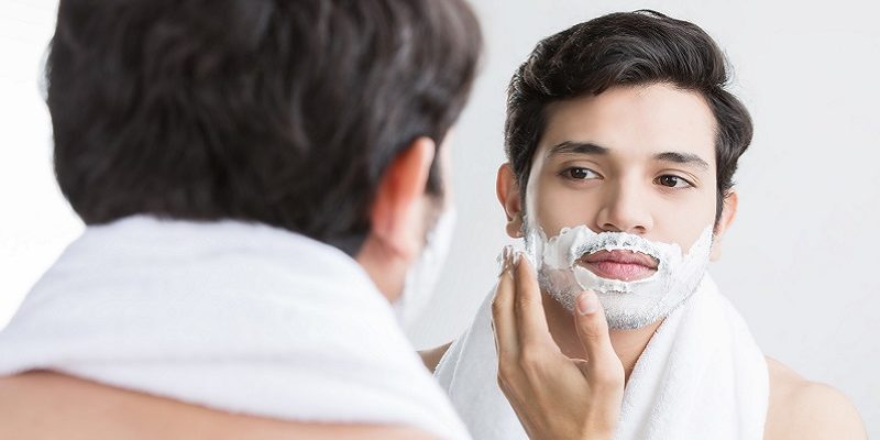 Man shaving in the bathroom.